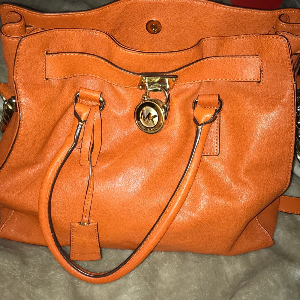 Orange Michael Kors bag with dust bag.